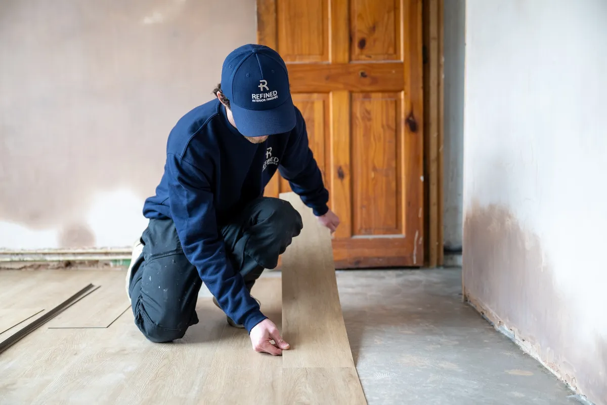 Refined Interior Finishes fitter installing LVT flooring in a Norwich home