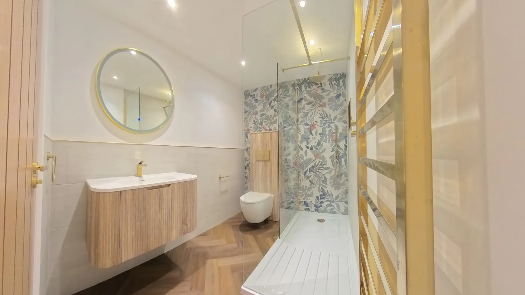 The main bathroom rebuilt with a walk-in shower, wall-hung vanity unit and feature tiling