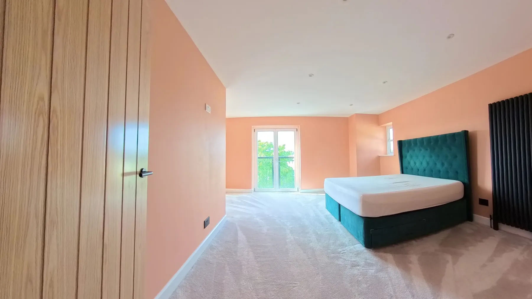 The main bedroom after redecoration, with the new carpet laid