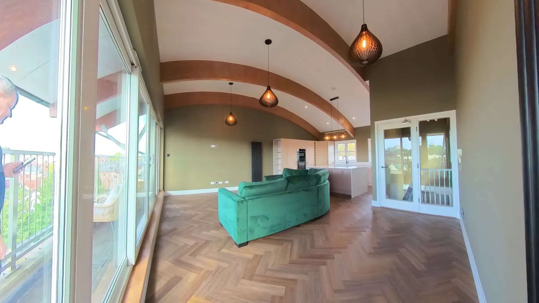 Open-plan living space with herringbone LVT flooring beneath the original exposed timber beams