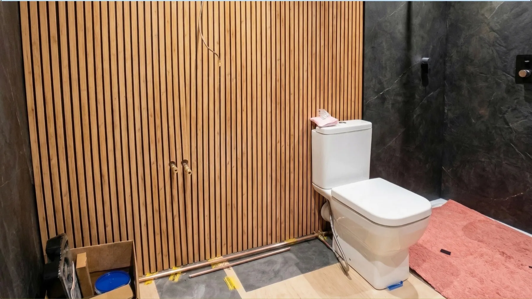 Decorative wall panelling and walk-in shower installation underway